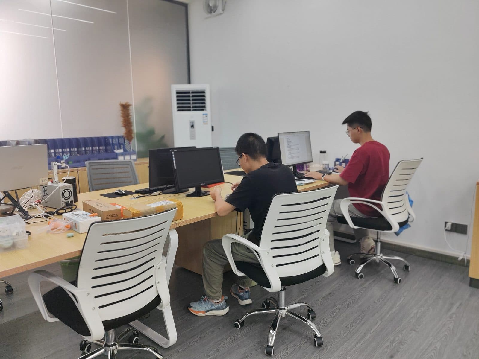SiLeap engineers reviewing baby nasal aspirator designs at workstations in the product development office
